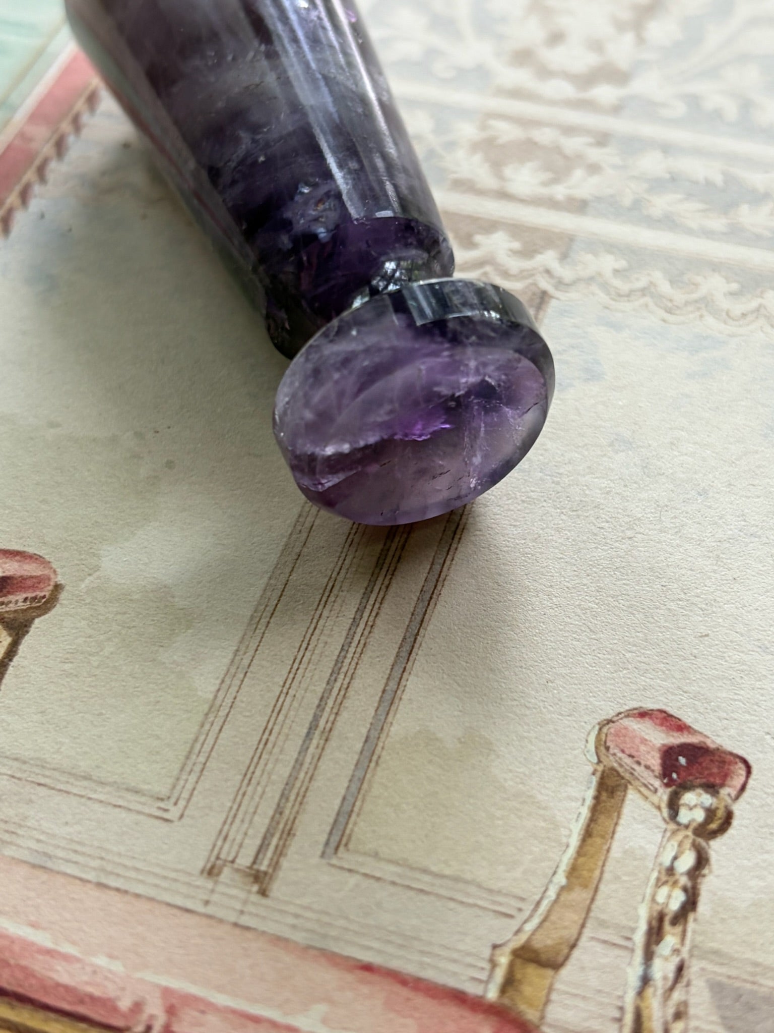 Close-up of the smooth oval seal face on the faceted amethyst wax seal stamp