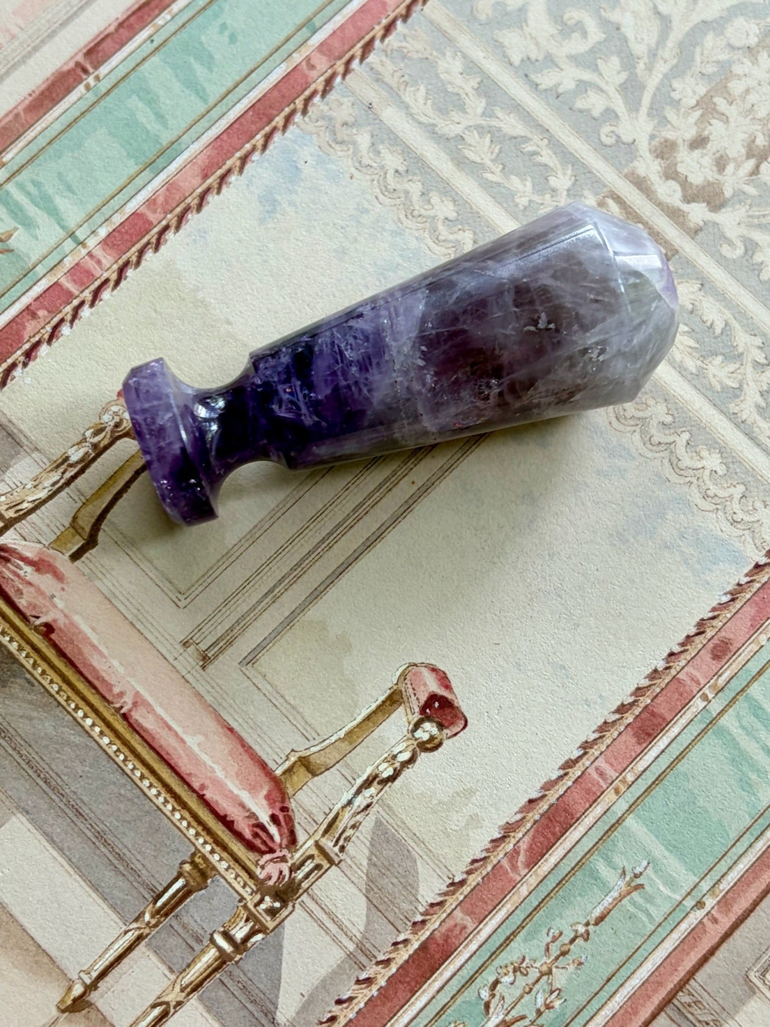 Side view of the faceted amethyst wax seal stamp showing its natural purple mineral striations