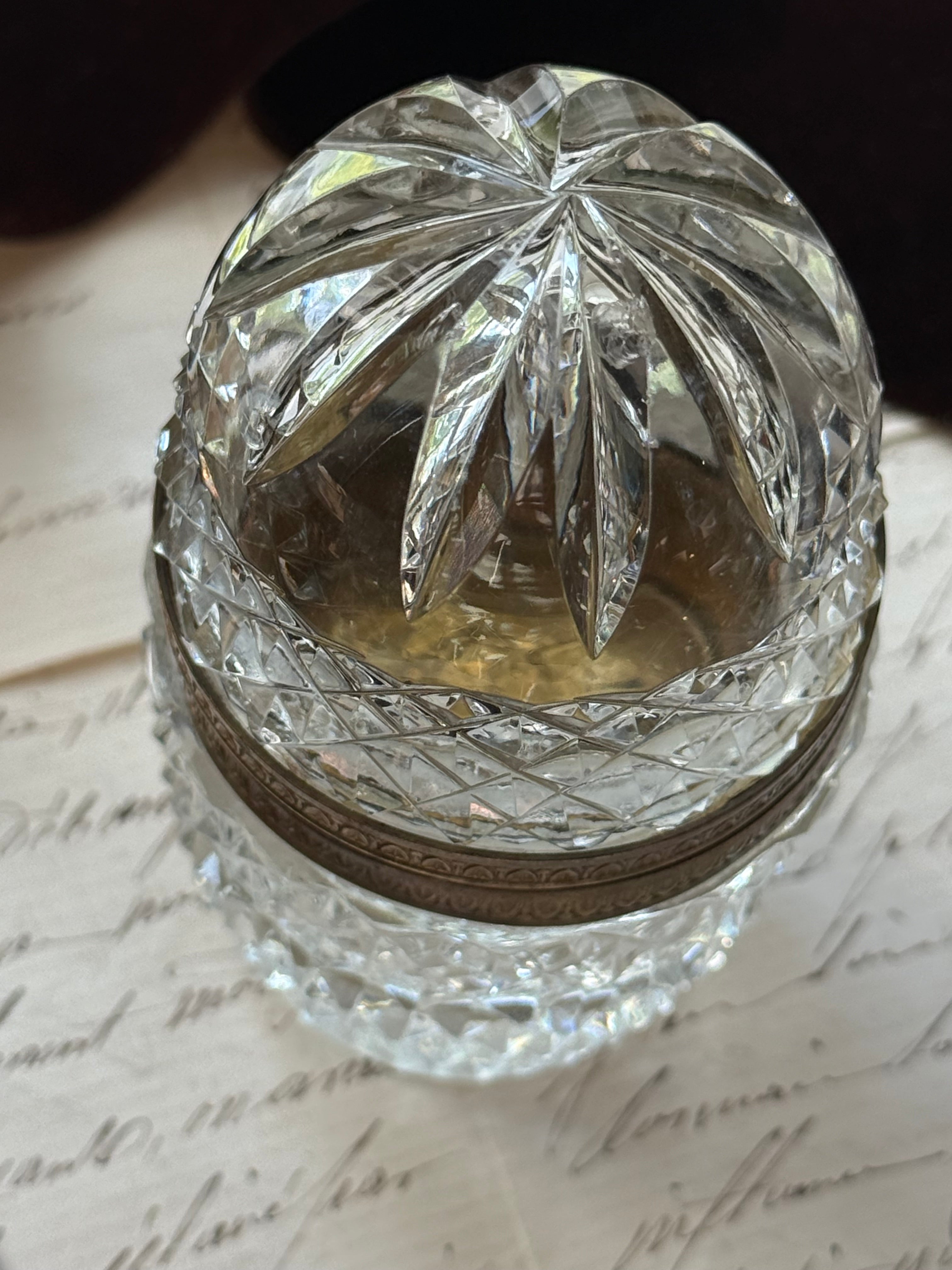 Overhead close-up of the crystal lid showing a fan-cut star pattern radiating from the domed top